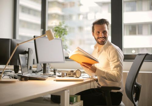 Man meditating calmly in a bright office space